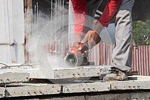 Builder worker with grinder machine cutting concreate floor