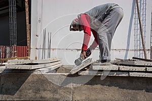 Builder worker with grinder machine cutting concreate floor