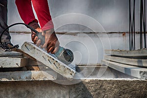 Builder worker with grinder machine cutting concreate floor