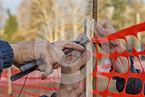 Builder worker Installing Construction Safety Fence 2