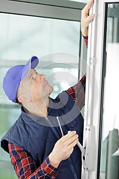 builder worker installing glass windows