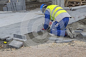 Builder worker installing the pavestone