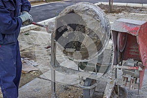 Builder Worker Mixing Cement