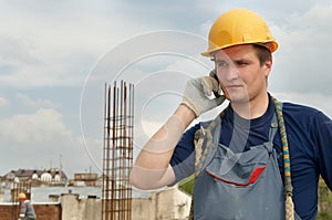 Builder worker with mobile phone