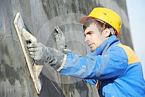 Builder worker at plastering facade work