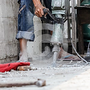 Builder worker with pneumatic hammer drill