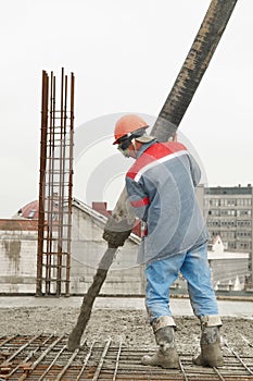 Builder worker pouring concrete