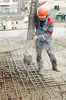 Builder worker pouring concrete