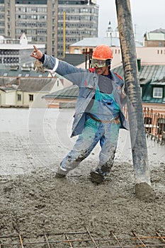 Builder worker pouring concrete