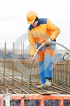 Builder worker pouring concrete