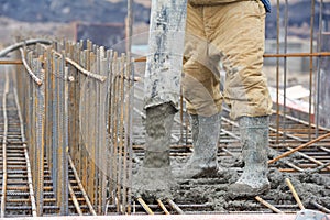 Builder worker pouring concrete into form