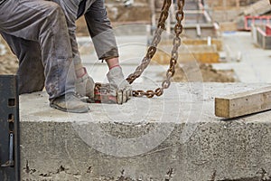 Builder worker preparing concrete profile for crane lifting 2