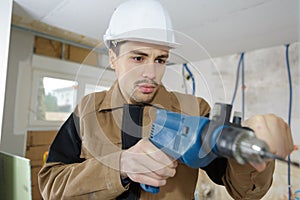 builder worker with r drill perforator equipment