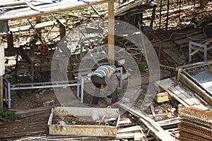 builder working with concrete mixer and prepares cement mortar