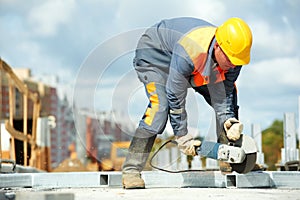 Builder working with cutting grinder photo