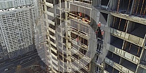 builders are building a house, an old multi-storey building