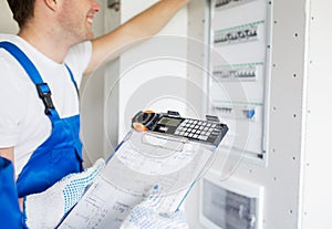 Builders with clipboard and electrical panel