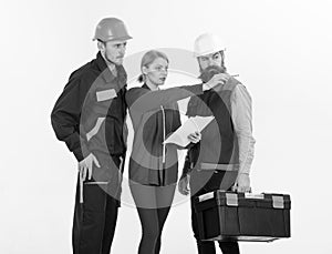 Builders at the construction site. Management concept. Men in hard hats and uniform