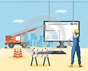 builders and desktop with webpage under cosntruction photo