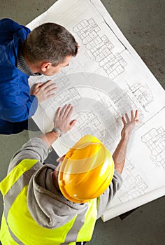 Builders examine blueprints