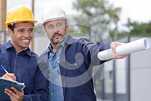 builders in helmets pointing outdoors