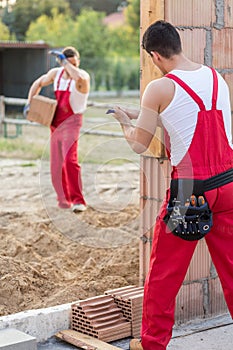 Builders at house construction site