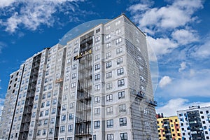 Builders, installers, high-rise workers, industrial climbers, plasterers on the lift, cladding of the facade of the