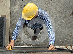 Builders installing measuring container