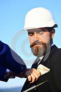 Builders make bargain. Workers put cash into engineers pocket.