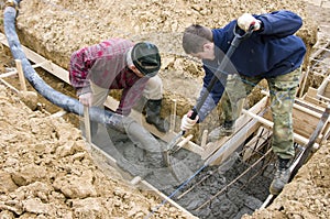 Builders making foundations