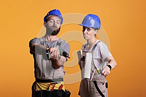Builders posing with construction or renovation tools