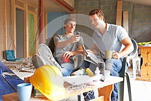 Builders Relaxing During Break On Site