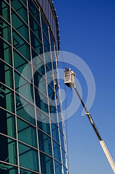 Builders repair facade on the crane
