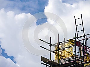 Builders scaffolding against sky