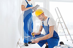 Builders with tablet pc and equipment indoors