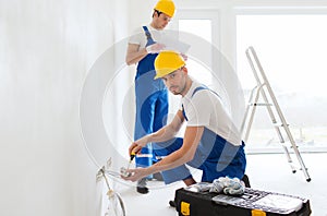 Builders with tablet pc and equipment indoors