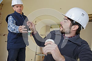 Builders talking while having coffee break