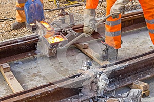 Builders weld and joining segments of the rail