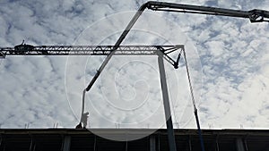 Builders work against the background of an assembly crane. Workers at a construction site against the backdrop of the construction