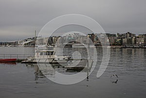 Buildigns of Aker Brigger, Oslo, Norway - cloudy evening and dark waters.