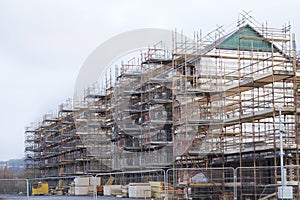 Building affordable homes with scaffolding safety by local construction council to help government social housing problem and shor