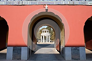 a building with arched arches and two columns with an intricate pattern