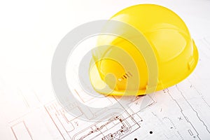 Building and architecture background, builder hard hat on engineering blueprints with copy space