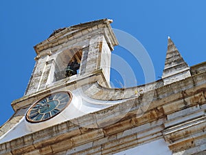 Arco da Vila, gate to the old town of Faro in Portugal, historic building with stork nest