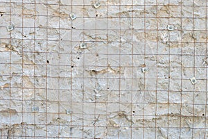 Building background prepared surface of the facade wall of the building with a fixed rusted mesh for cementing and