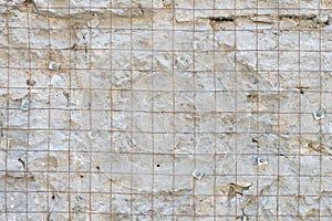 Building background prepared surface of the facade wall of the building with a fixed rusted mesh for cementing and