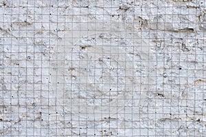 Building background prepared surface of the facade wall of the building with a fixed rusted mesh for cementing and