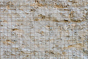 Building background prepared surface of the facade wall of the building with a fixed rusted mesh for cementing and