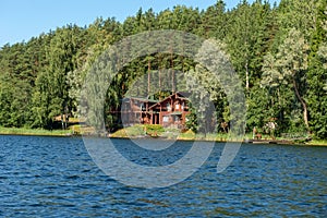 Building with a boat dock on the forest lake