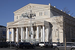 The building of the Bolshoi Theater with the famous team of horses on the facade against the background of the spring blue sky